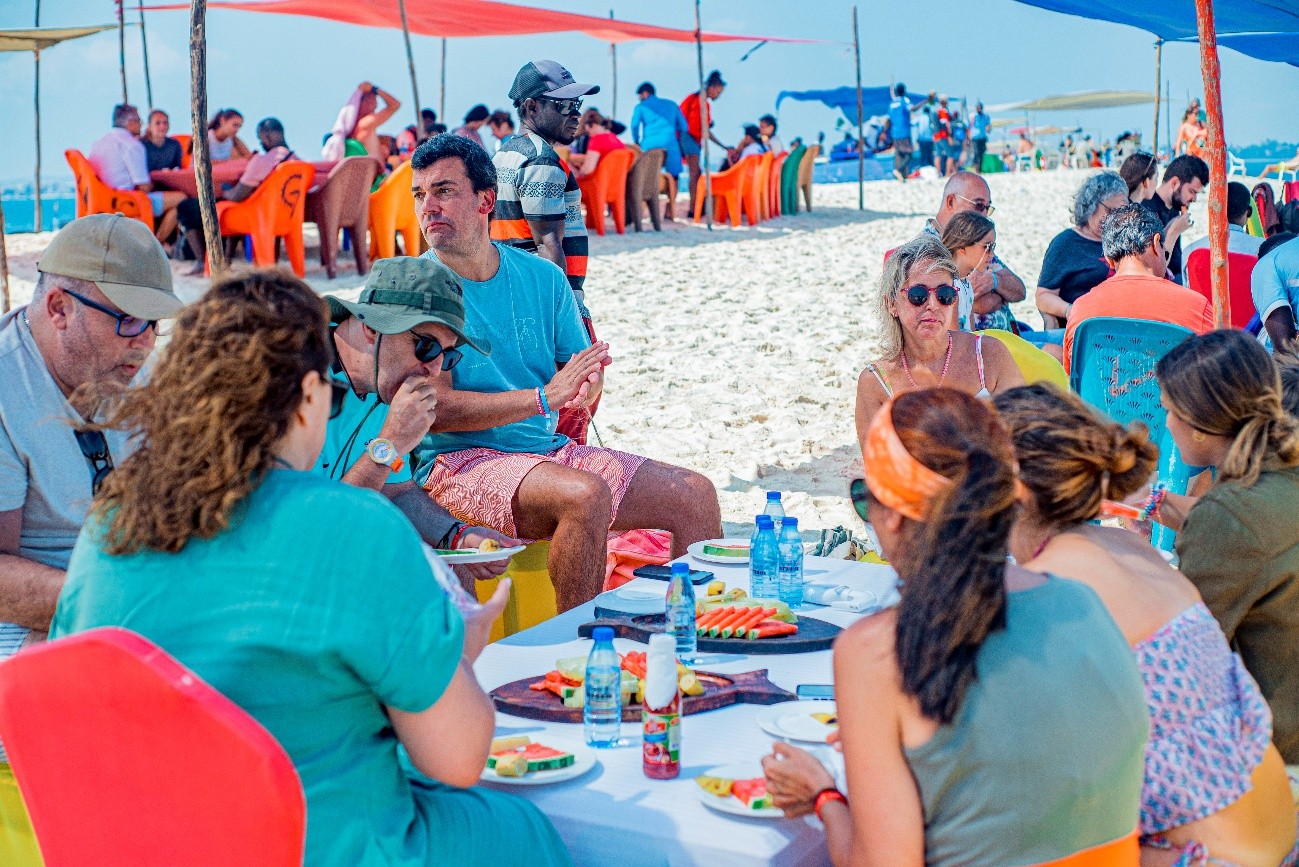 A group of people dining on the beach at Nakupenda Sandbank
